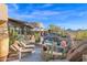 Expansive outdoor area with a pool and lounge seating against desert landscaping and clear skies at 34460 N 79Th Way, Scottsdale, AZ 85266