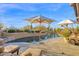 Tranquil pool with desert landscaping creating a serene and private oasis at 34460 N 79Th Way, Scottsdale, AZ 85266