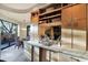 Granite countertop with sink, cabinets, and open shelves at 34460 N 79Th Way, Scottsdale, AZ 85266