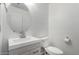 Bathroom with a modern vanity, circular mirror, and white fixtures at 363 E Leslie Ave, San Tan Valley, AZ 85140