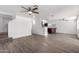 Open floor plan living room with stairs and adjoined kitchen and modern wood-look flooring at 363 E Leslie Ave, San Tan Valley, AZ 85140