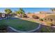 Lush backyard featuring a well-maintained lawn, mature landscaping, and a safety fence for the pool at 3706 E Ravenswood Dr, Gilbert, AZ 85298