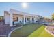 Expansive backyard with a covered patio and a pristine green lawn, perfect for outdoor living and entertaining at 3706 E Ravenswood Dr, Gilbert, AZ 85298