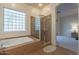 Bathroom showcasing a glass-enclosed shower, separate tub, and neutral tile at 3706 E Ravenswood Dr, Gilbert, AZ 85298
