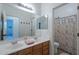 Bathroom with double sink vanity and a shower behind a decorative curtain at 3706 E Ravenswood Dr, Gilbert, AZ 85298