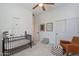 Bedroom featuring a crib, rocking chair, neutral walls, and natural light at 3706 E Ravenswood Dr, Gilbert, AZ 85298