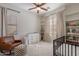 Bedroom featuring a crib, changing table, rocking chair, and built in shelving at 3706 E Ravenswood Dr, Gilbert, AZ 85298