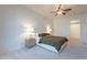 A bright bedroom featuring a ceiling fan, cozy carpet, and neutral walls at 3706 E Ravenswood Dr, Gilbert, AZ 85298