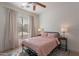 Bedroom featuring light pink bedding, wood floors, neutral drapes, and natural light at 3706 E Ravenswood Dr, Gilbert, AZ 85298