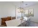 Bright dining room featuring a modern light fixture, light walls and seating for six at 3706 E Ravenswood Dr, Gilbert, AZ 85298