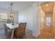 Bright dining area featuring a stylish chandelier, neutral color scheme, and a large window at 3706 E Ravenswood Dr, Gilbert, AZ 85298