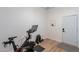 An exercise room featuring a peloton bike, free weights, and wood floors at 3706 E Ravenswood Dr, Gilbert, AZ 85298