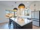 Bright kitchen with center island, pendant lighting, quartz countertops and stainless steel appliances at 3706 E Ravenswood Dr, Gilbert, AZ 85298