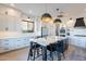 Bright kitchen featuring white cabinets, stainless steel appliances, and a central island with bar seating at 3706 E Ravenswood Dr, Gilbert, AZ 85298