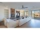 Bright living room with a stone fireplace, built-in shelving, and sliding glass doors at 3706 E Ravenswood Dr, Gilbert, AZ 85298