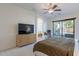 Relaxing main bedroom with a ceiling fan, work space, and plenty of natural light at 3706 E Ravenswood Dr, Gilbert, AZ 85298