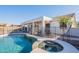 Enjoy a refreshing dip in the pool and relax in the spa of this home's beautiful backyard oasis at 3706 E Ravenswood Dr, Gilbert, AZ 85298