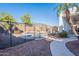 A sparkling pool is surrounded by desert landscaping and a secure safety fence at 3706 E Ravenswood Dr, Gilbert, AZ 85298