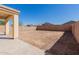 Spacious dirt backyard enclosed by a block fence and covered patio offers plenty of potential at 37379 W Amalfi Ave, Maricopa, AZ 85138