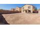 Large, bare backyard is ready for landscaping and outdoor activities, surrounded by block fencing at 37379 W Amalfi Ave, Maricopa, AZ 85138