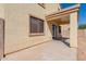 Exterior view of a home's backyard patio and stucco wall at 37379 W Amalfi Ave, Maricopa, AZ 85138