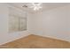 Bright bedroom with carpet flooring, a ceiling fan, and a window with natural light at 37379 W Amalfi Ave, Maricopa, AZ 85138