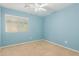 Cozy bedroom with carpet flooring, a ceiling fan, and a window with natural light at 37379 W Amalfi Ave, Maricopa, AZ 85138