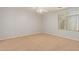 Spacious bedroom featuring plush carpeting, ceiling fan, and a large window at 37379 W Amalfi Ave, Maricopa, AZ 85138