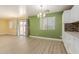 Dining area with wood floors, natural light, sliding glass doors, and views of backyard at 37379 W Amalfi Ave, Maricopa, AZ 85138