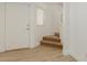 Bright entryway with light wood flooring and a staircase leading to the upper level at 37379 W Amalfi Ave, Maricopa, AZ 85138