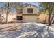 Beige two-story home showcasing a two-car garage and low-maintenance desert landscaping at 37379 W Amalfi Ave, Maricopa, AZ 85138