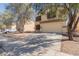 Beige two-story home featuring a driveway, two-car garage, and low-maintenance desert landscaping at 37379 W Amalfi Ave, Maricopa, AZ 85138
