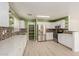 Bright kitchen featuring stainless steel appliances, white cabinets, and stylish backsplash at 37379 W Amalfi Ave, Maricopa, AZ 85138