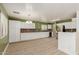 Bright kitchen featuring white cabinets, stainless steel appliances, and wood flooring at 37379 W Amalfi Ave, Maricopa, AZ 85138