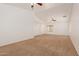 Large living room featuring carpet flooring, neutral walls, and ceiling fan at 37379 W Amalfi Ave, Maricopa, AZ 85138
