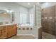 This bathroom features a vanity with tiled countertops, and tiled shower and glass block walls at 38820 N 10Th St, Phoenix, AZ 85086