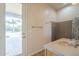 Ensuite bathroom features vanity with stone countertop, wooden cabinets, and direct access to the backyard at 38820 N 10Th St, Phoenix, AZ 85086