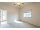 Bright bedroom with carpet flooring, ceiling fan and private access to the backyard patio at 38820 N 10Th St, Phoenix, AZ 85086