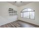 An empty bedroom with wood floors, bright natural light, and built in shelving on one wall at 38820 N 10Th St, Phoenix, AZ 85086