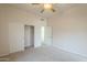 Neutral bedroom with carpet flooring, ceiling fan, closet and access to an ensuite bathroom at 38820 N 10Th St, Phoenix, AZ 85086