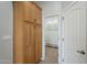 A closet with beautiful wood cabinets and access to a closet behind a door at 38820 N 10Th St, Phoenix, AZ 85086