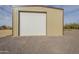 A large detached garage with a white garage door on a gravel lot at 38820 N 10Th St, Phoenix, AZ 85086
