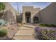 Inviting desert home featuring a tranquil walkway, desert landscaping, and a private front entrance at 38820 N 10Th St, Phoenix, AZ 85086