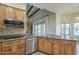 Stylish kitchen with granite countertops, stainless steel appliances, wood cabinets, and backyard access at 38820 N 10Th St, Phoenix, AZ 85086
