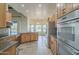 Eat-in kitchen featuring wood cabinets, stainless steel appliances and a picturesque view of the backyard pool at 38820 N 10Th St, Phoenix, AZ 85086