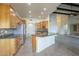 Open floorplan kitchen features a kitchen island and stainless steel appliances and wood cabinets at 38820 N 10Th St, Phoenix, AZ 85086