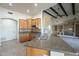 Modern kitchen featuring granite countertops and wooden cabinets with seamless access to the expansive living room at 38820 N 10Th St, Phoenix, AZ 85086