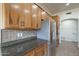 Spacious kitchen boasts stainless steel appliances, granite countertops, tile backsplash, and wood cabinets at 38820 N 10Th St, Phoenix, AZ 85086