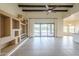 Bright living room with decorative ceiling beams, custom built-ins, and seamless access to a private pool area at 38820 N 10Th St, Phoenix, AZ 85086