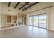 Spacious living room features beamed ceilings, media center, and large glass doors leading to a private outdoor pool at 38820 N 10Th St, Phoenix, AZ 85086